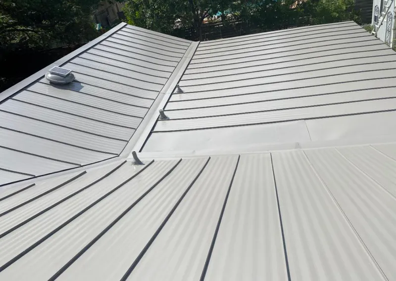 Solar attic fan installed on a metal roof for Roof Ventilation in Forest Hill